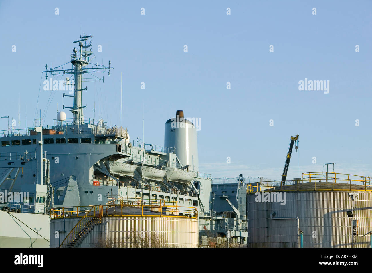 An oil storage depot and war ship in Birkenhead near Liverpool England Stock Photo
