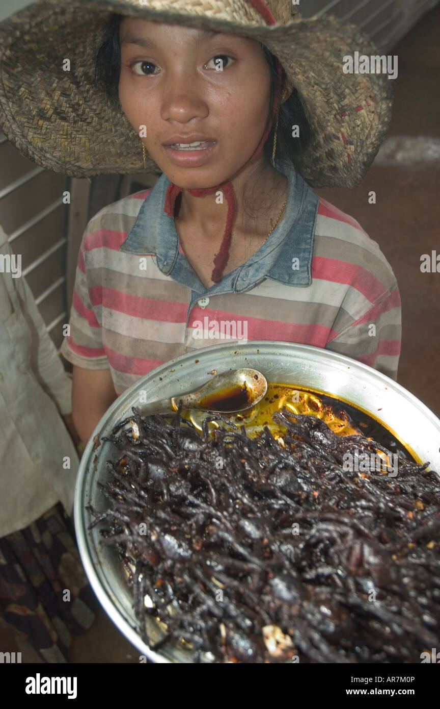 Khmer woman selling trays of beer snack fried black Thailand Zebra Leg tarantula spiders at Skuon, Cambodia Stock Photo