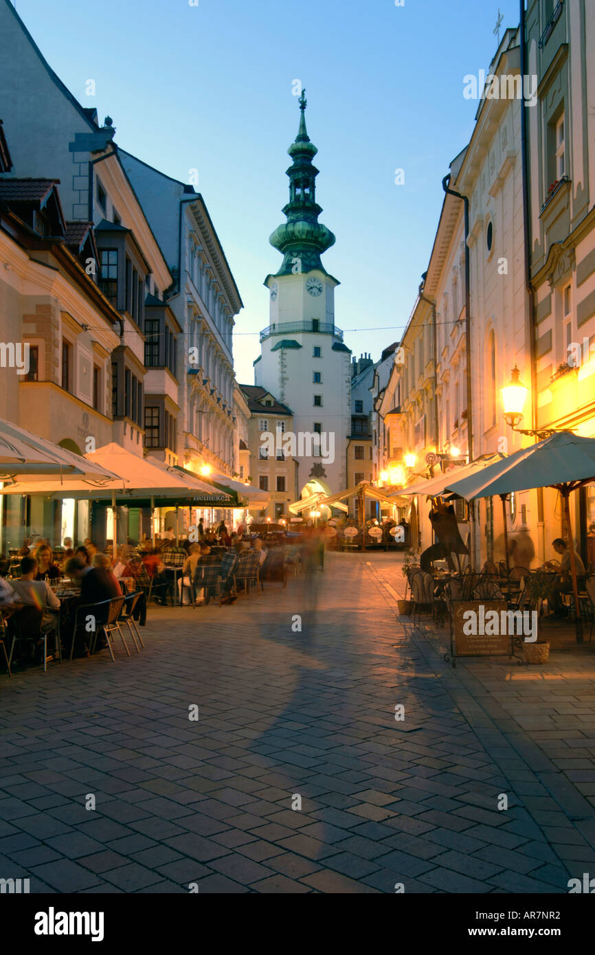 Dusk view of St Michael's Tower and sidewalk cafes in the old town of Bratislava, the capital of Slovakia. Stock Photo