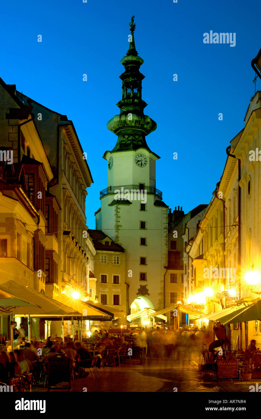 Dusk view of St Michael's Tower and sidewalk cafes in the old town of Bratislava, the capital of Slovakia. Stock Photo