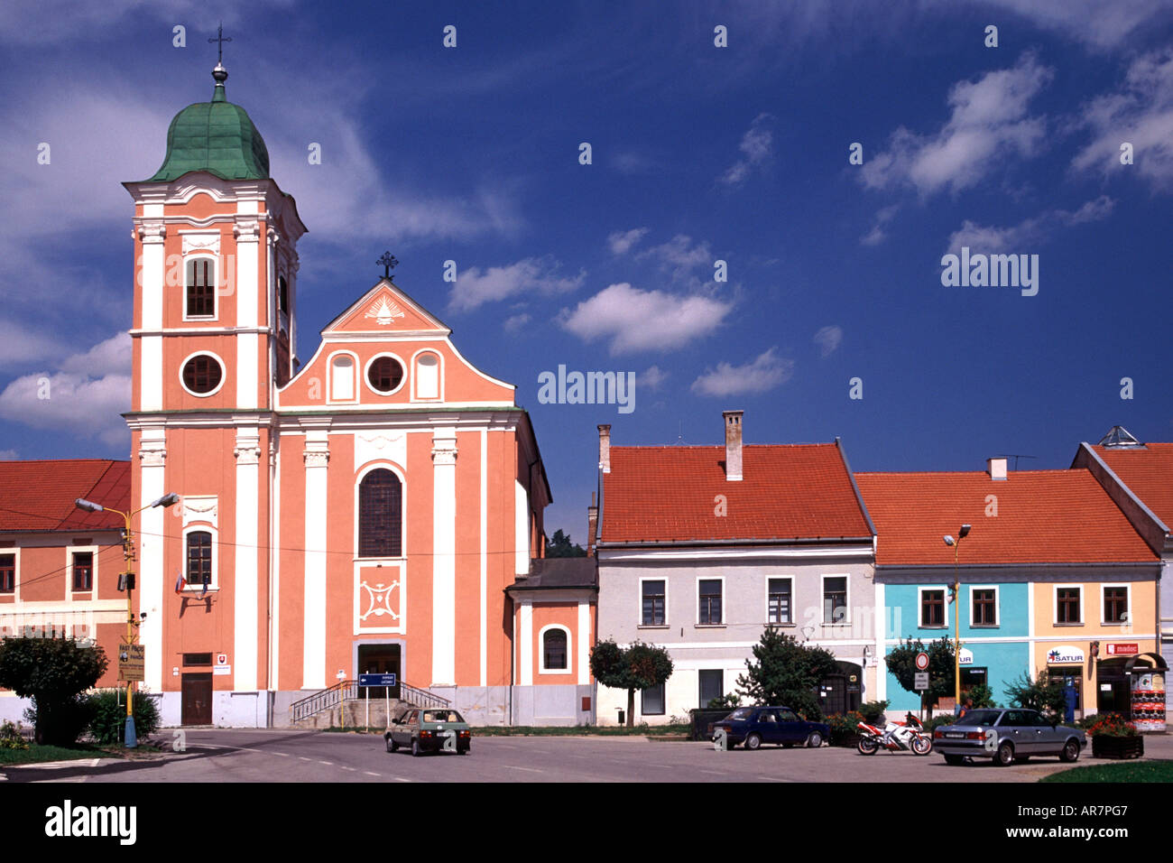 Colourful church and buildings in the town of Roznava in eastern Slovakia. Stock Photo