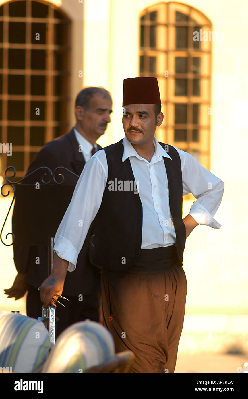 Fez hat wearing waiter in tradtional dress at the Mir Amin Hotel former  palace of the Druze Prince Emir Amin located in the Chou Stock Photo - Alamy