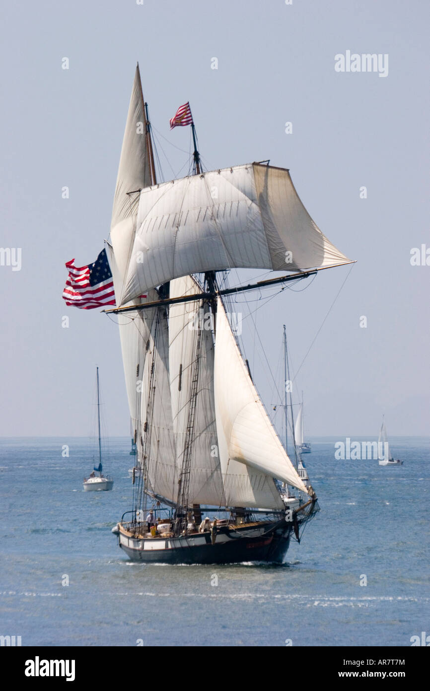 A graceful tall ship is seen under full sail under fair skies Stock Photo