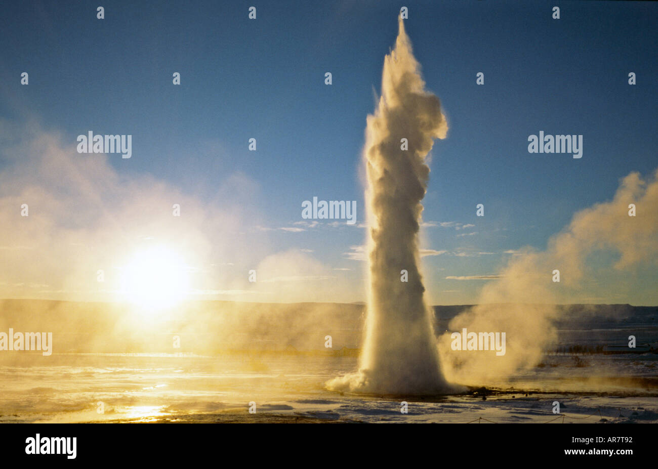 Strokkur geyser, in Haukadalur geothermal area, erupting and spouting its water 21 meters into the air, during a winter sunrise in Geysir, Iceland Stock Photo