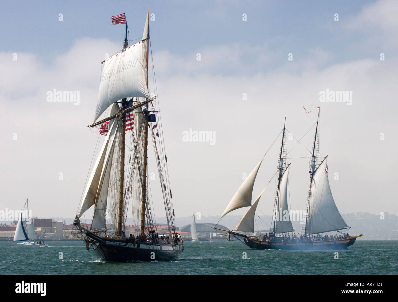 Two graceful tall ships are seen sailing in San Diego Bay. Stock Photo