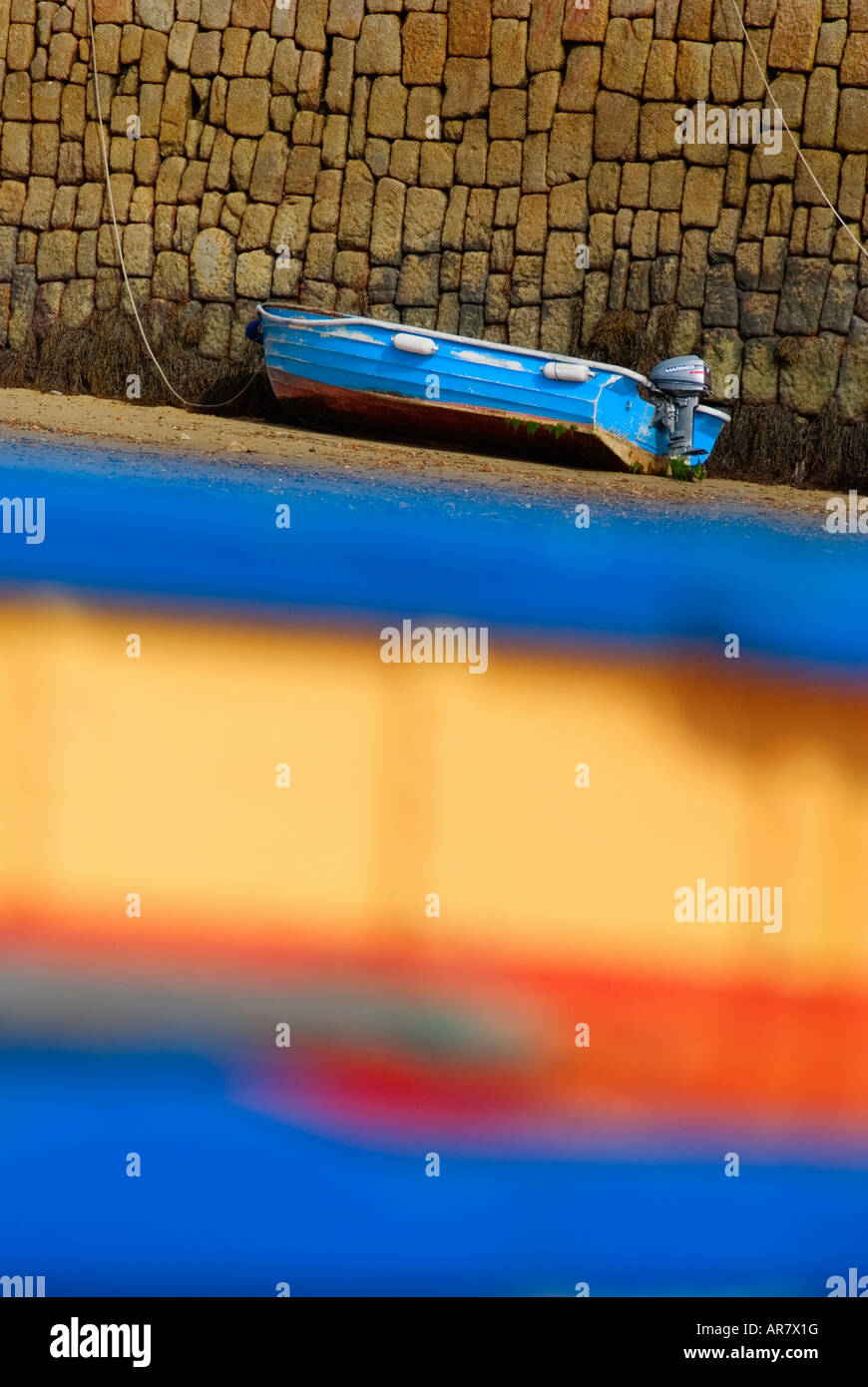 Boat moored against harbour wall at low tide on St Marys island Isles of Scilly England UK Stock Photo