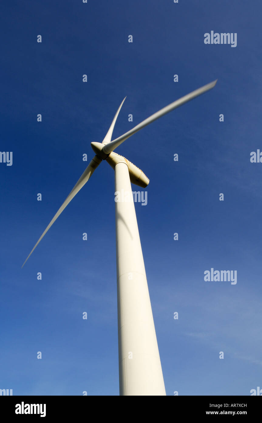 A single wind turbine set against a blue sky Stock Photo - Alamy