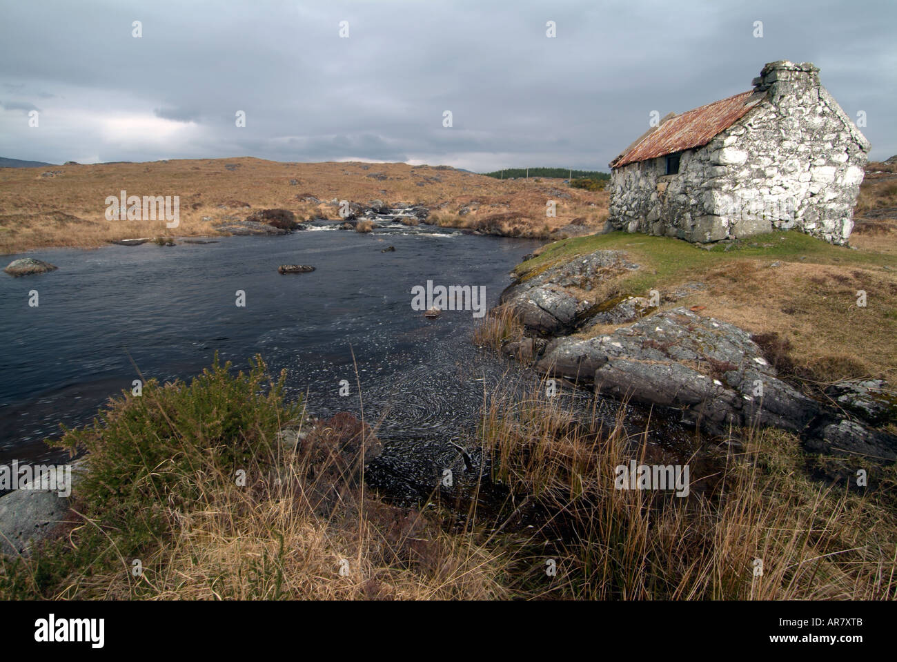 Cloudy grey skies over a fishermans cottage near Maam Cross, County galway, Ireland Stock Photo