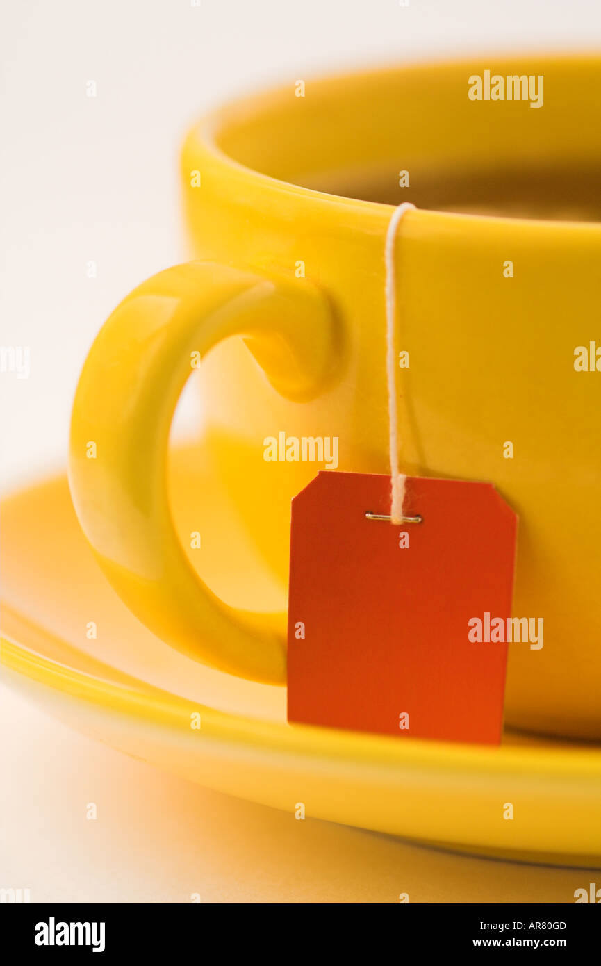 a cup of tea with a red tea label Stock Photo Alamy