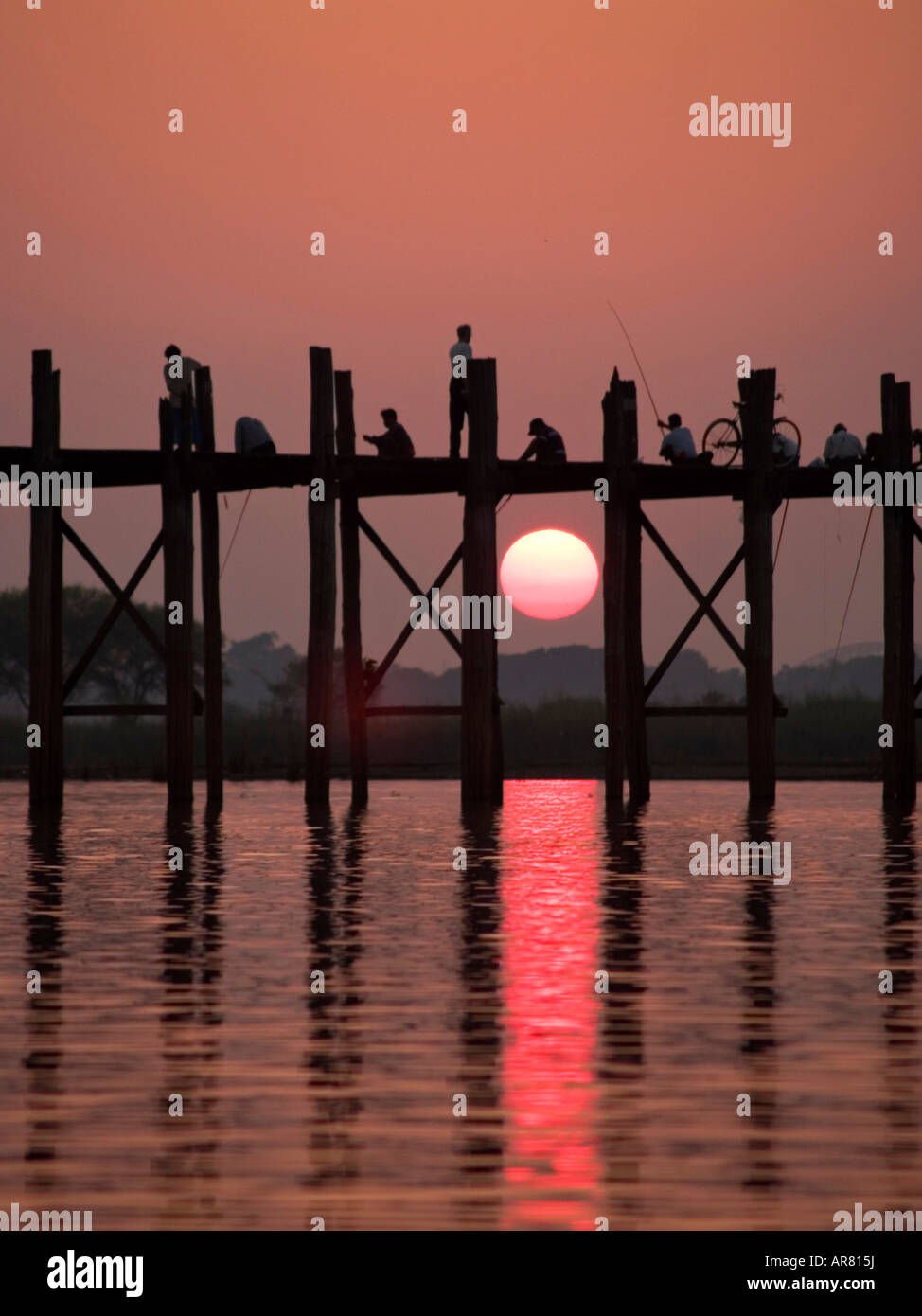 silhouettes at sunset on the U Bein Bridge in Burma Stock Photo - Alamy