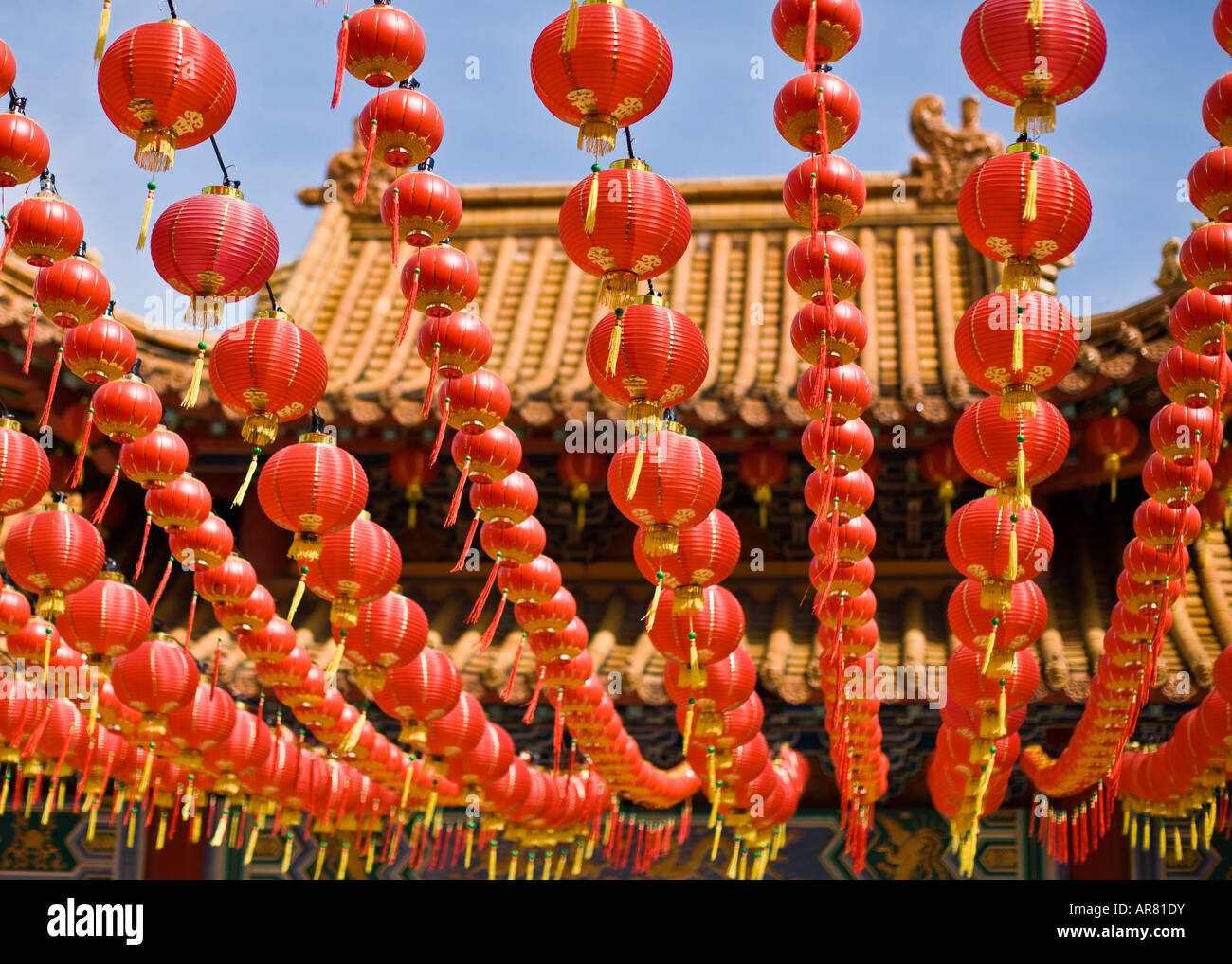 Red Chinese lanterns hanging across a temple during Chinese New Year ...
