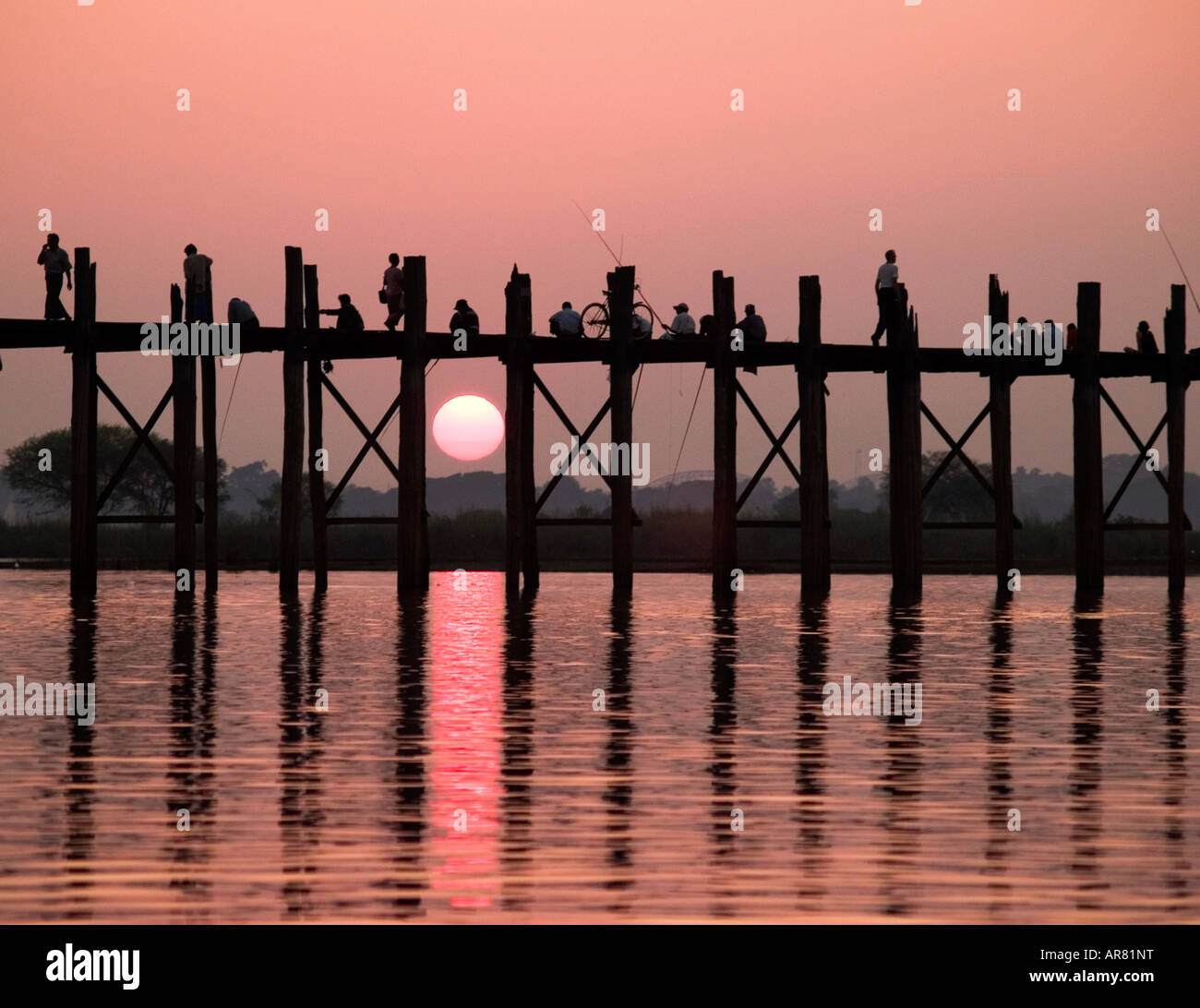 fishermen on the U Bein teak bridge at sunset in Myanmar Stock Photo ...