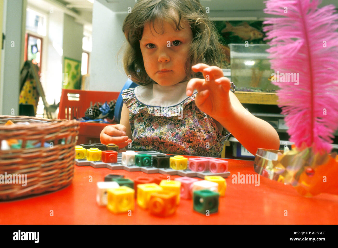 Young child learning to count with toy blocks Stock Photo