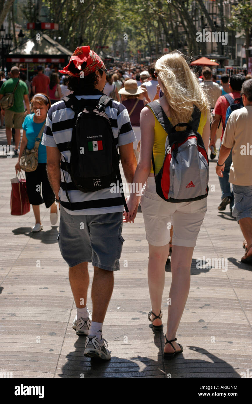 Two young backpackers troll hand in hand along the Ramblas in Barcelona,  Spain Stock Photo - Alamy