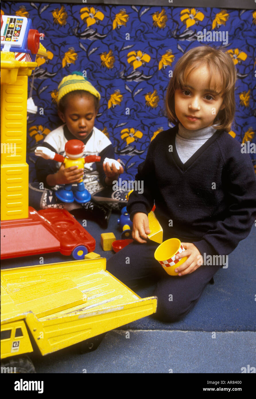 Girl and boy playing at nursery school Stock Photo