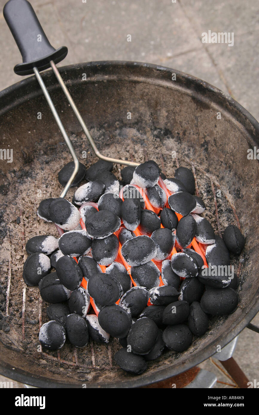 Lighting a charcoal grill with an electric heating tool Stock Photo Alamy