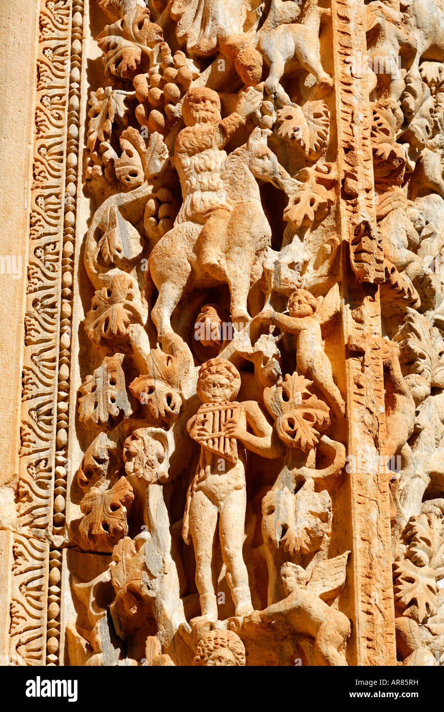 Ornately sculpted pillar with figures from the Dionysian procession at the Basilica of Severus Leptis Magna Libya Stock Photo