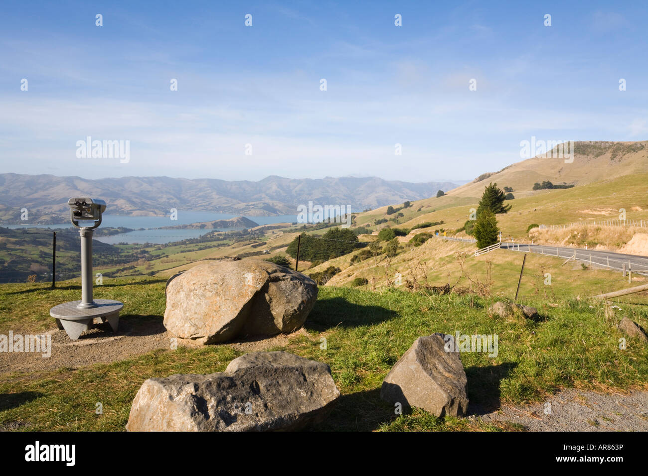 View down to Barrys Bay in 'Banks Peninsula' from roadside Hilltop viewpoint South Island New Zealand Stock Photo