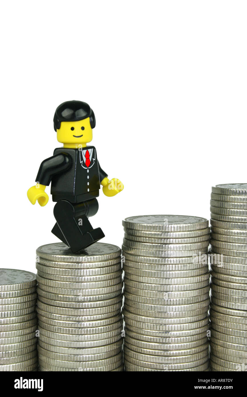 Lego businessman climbing steps of money - business success concept Stock Photo