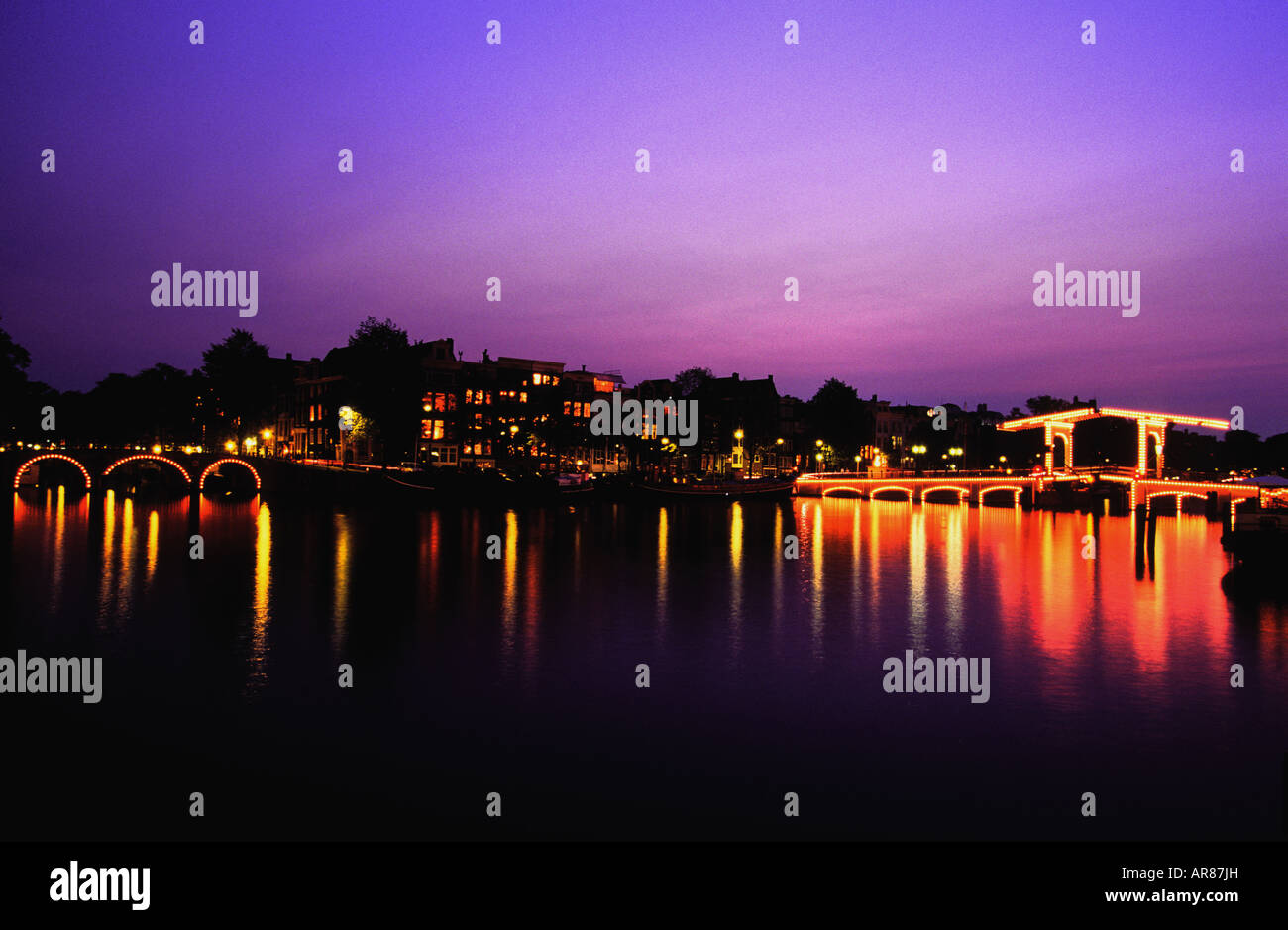 view of amstel canal and skinny bridge at sunset in amsterdam Stock Photo