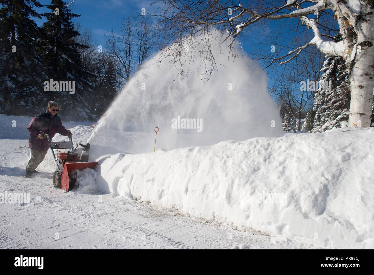 Man using a snowblower on a driveway in Montreal Canada during the winter of 2007 2008 Stock Photo