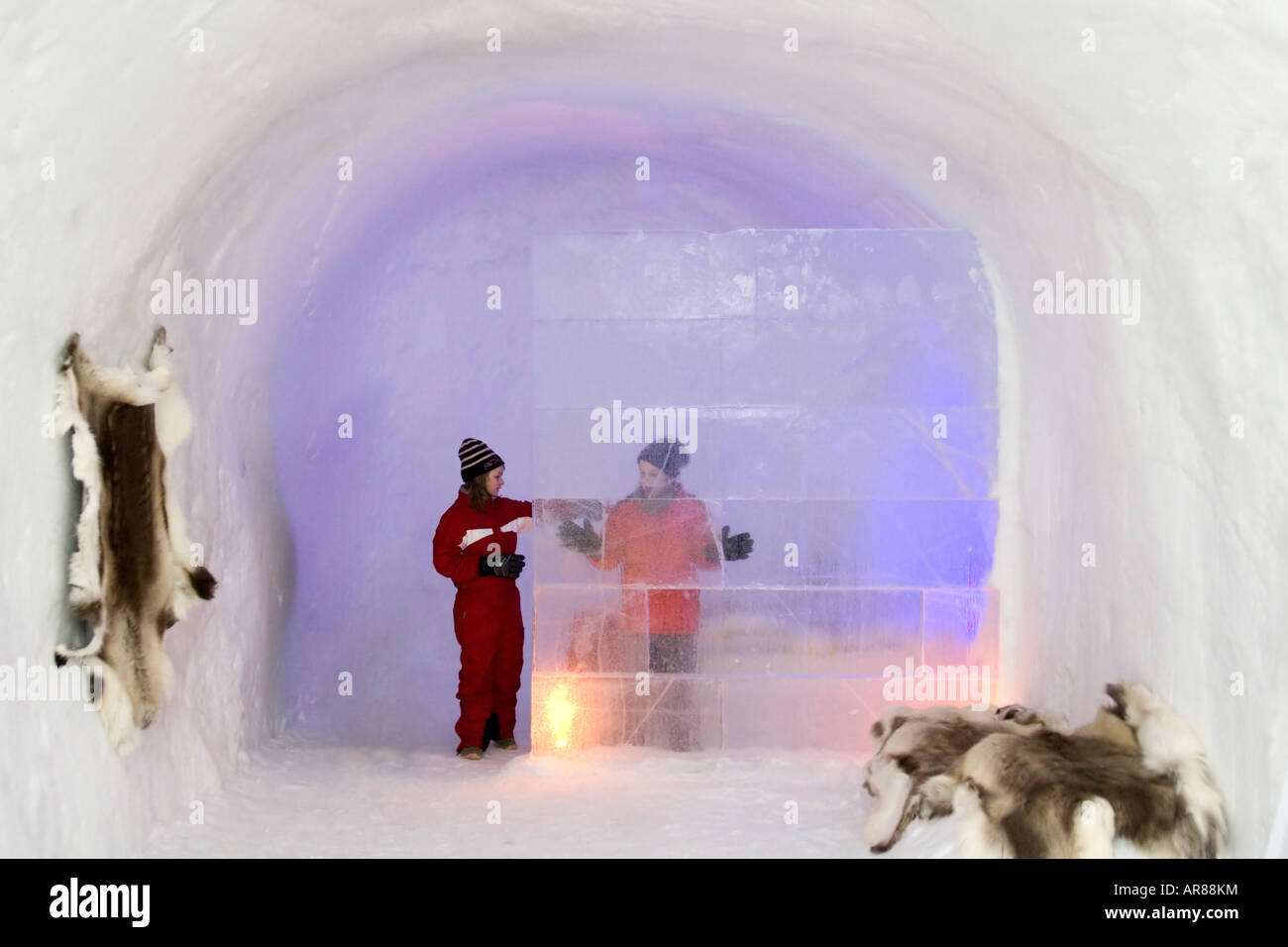 Children behind a wall made of ice at an ice hotel in Norway Stock Photo