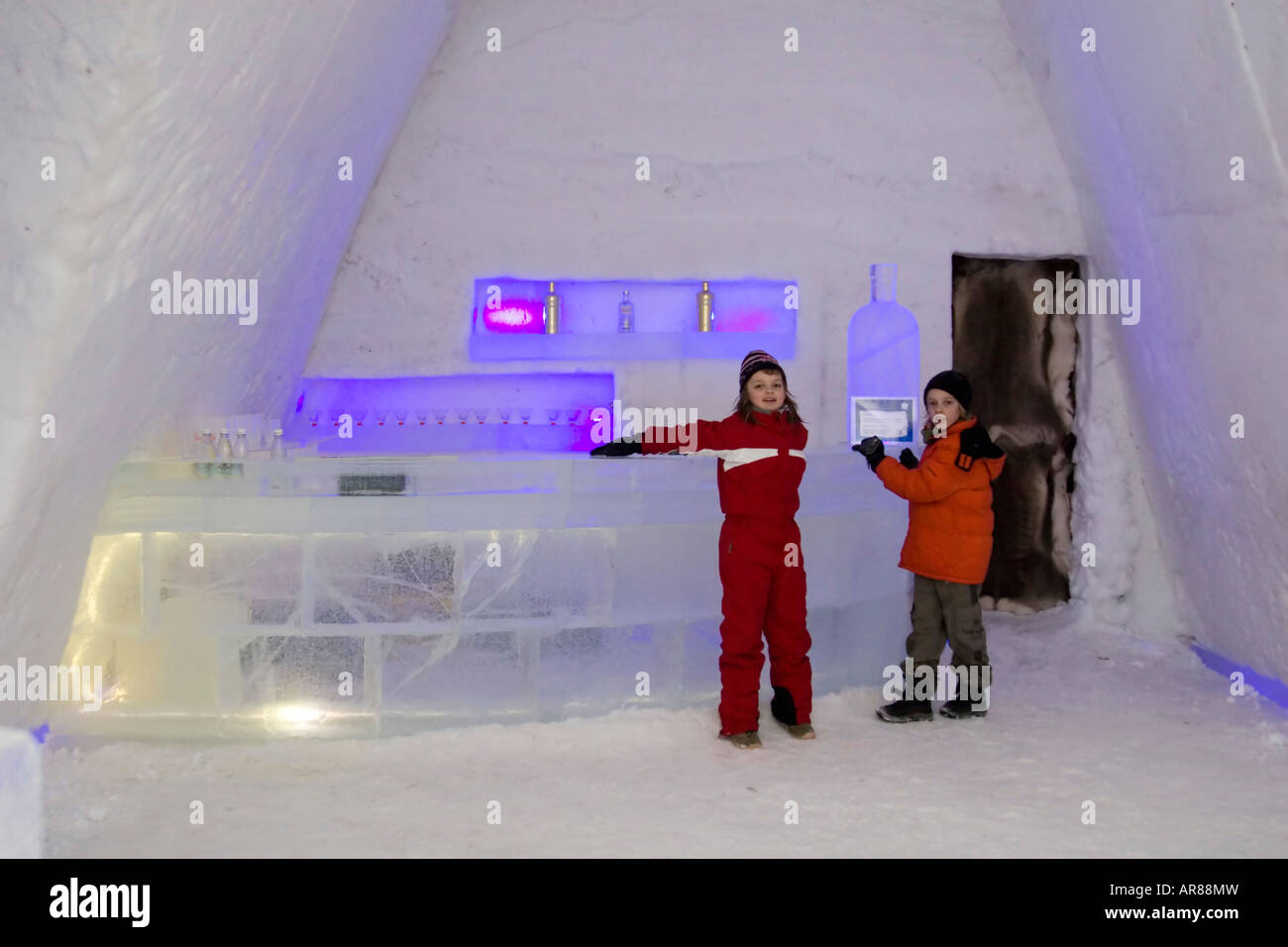 Young children in winter clothes in an ice bar in Norway Stock Photo