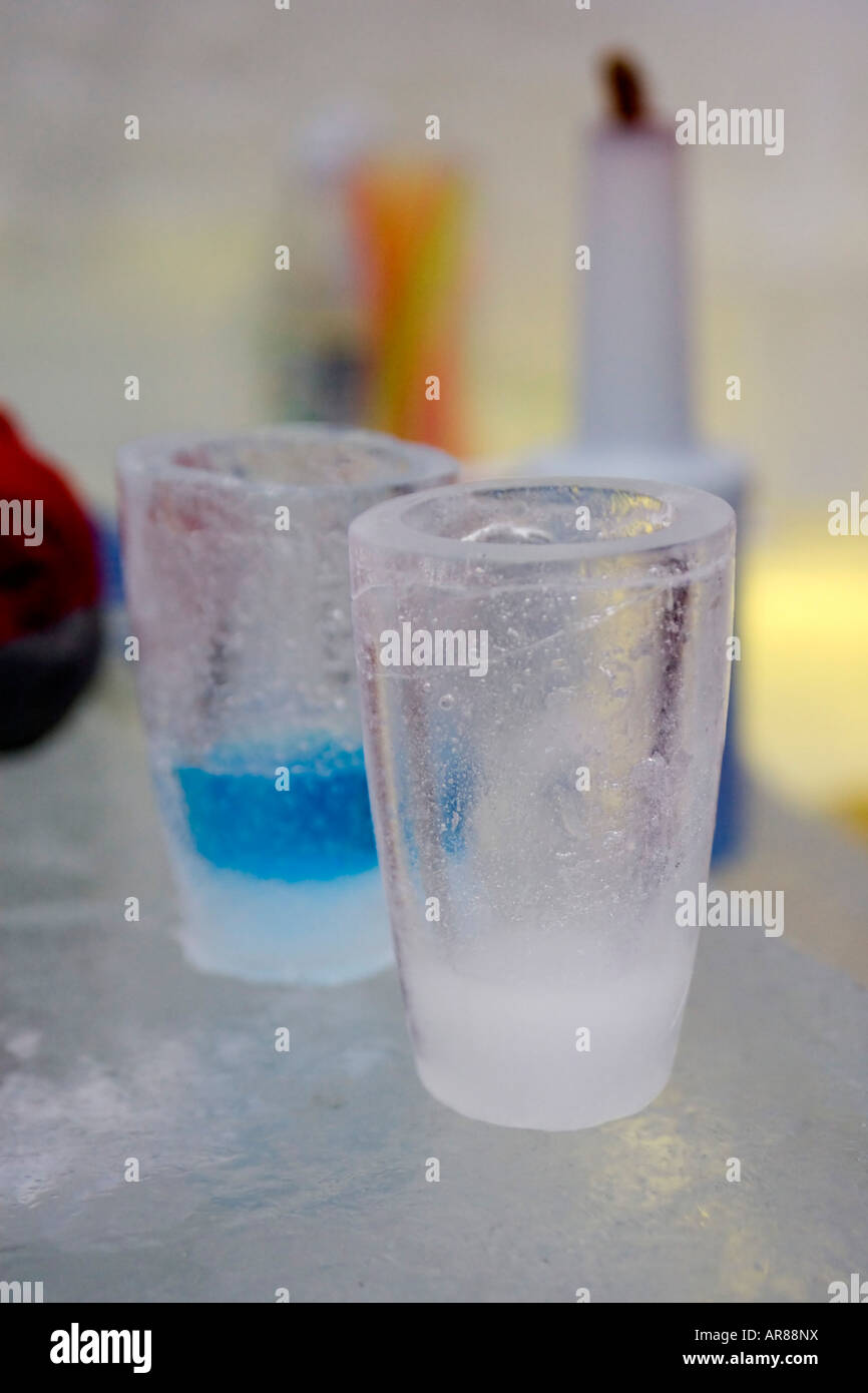 Coloured vodka in a drinks shot glass made of ice in an ice bar in Norway Stock Photo