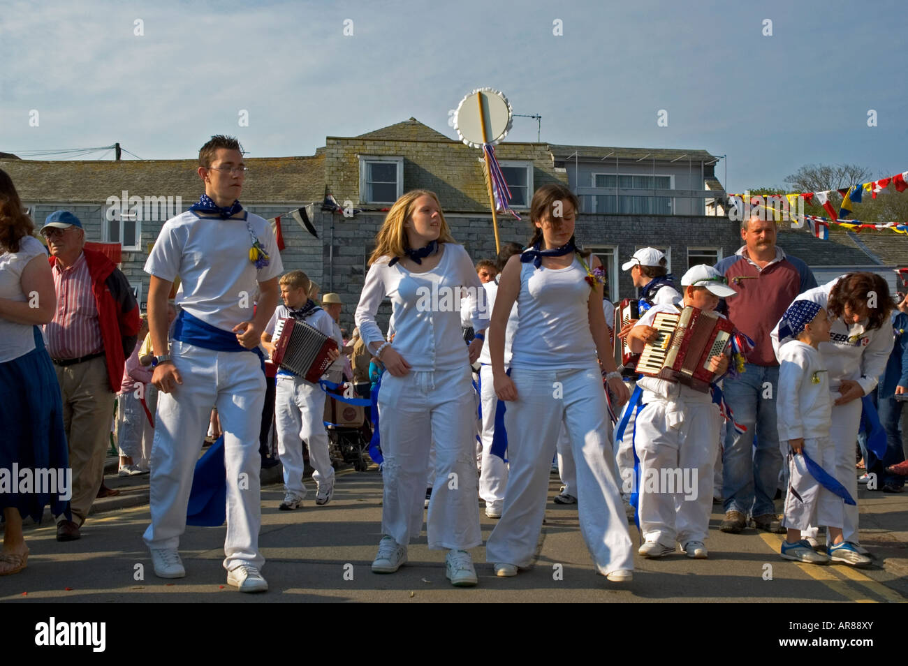 teenagers dancing in the streets of padstow,cornwall,on obby oss day. Stock Photo