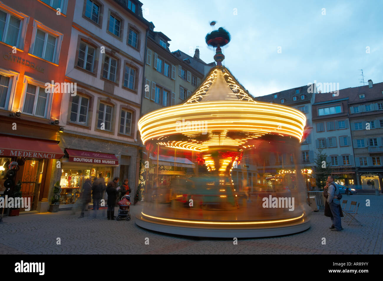 Carousel in the Christmas market at dusk - Strasbourg France Stock Photo