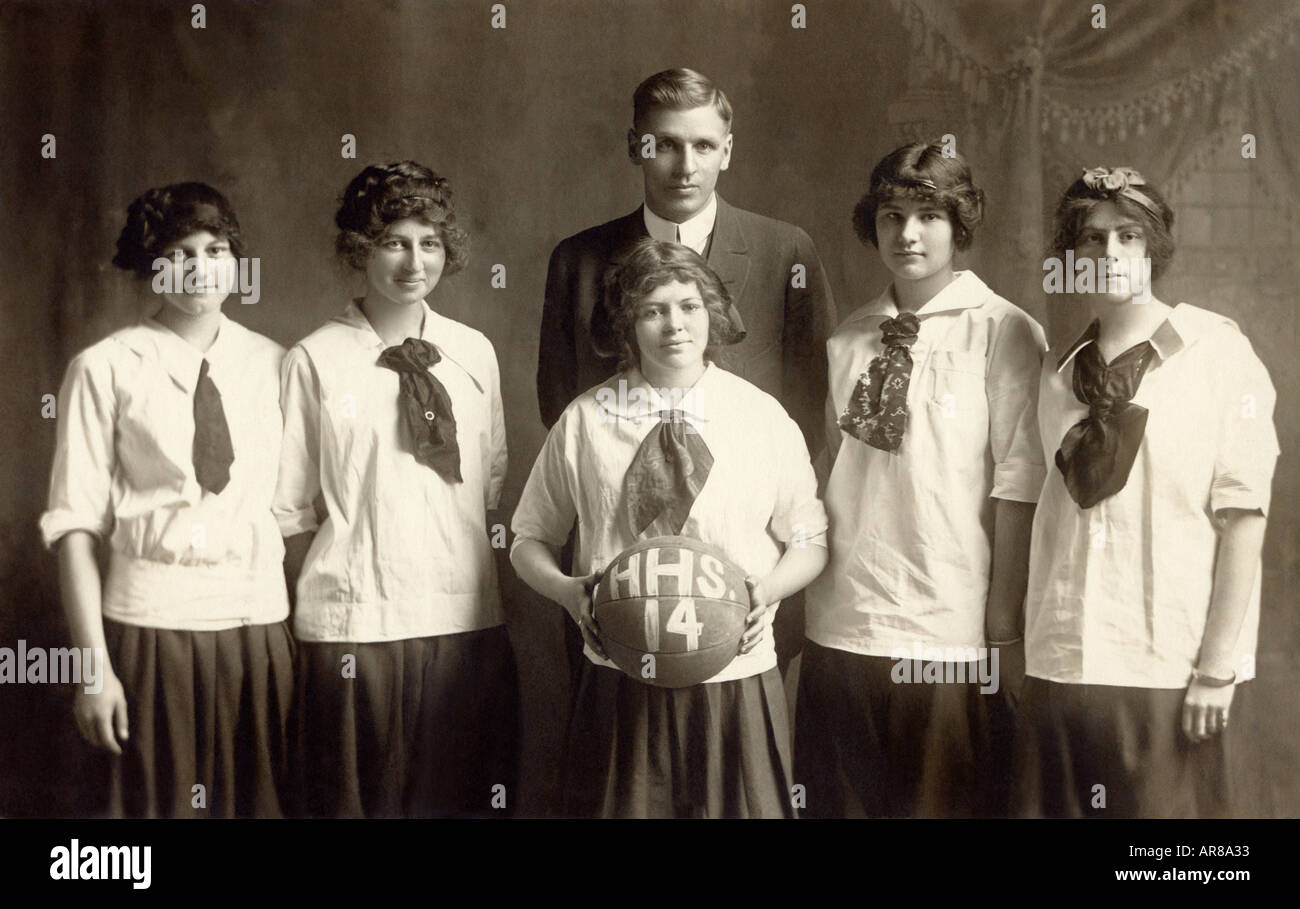 Vintage Portrait For Girls Basketball Team With Coach Stock Photo