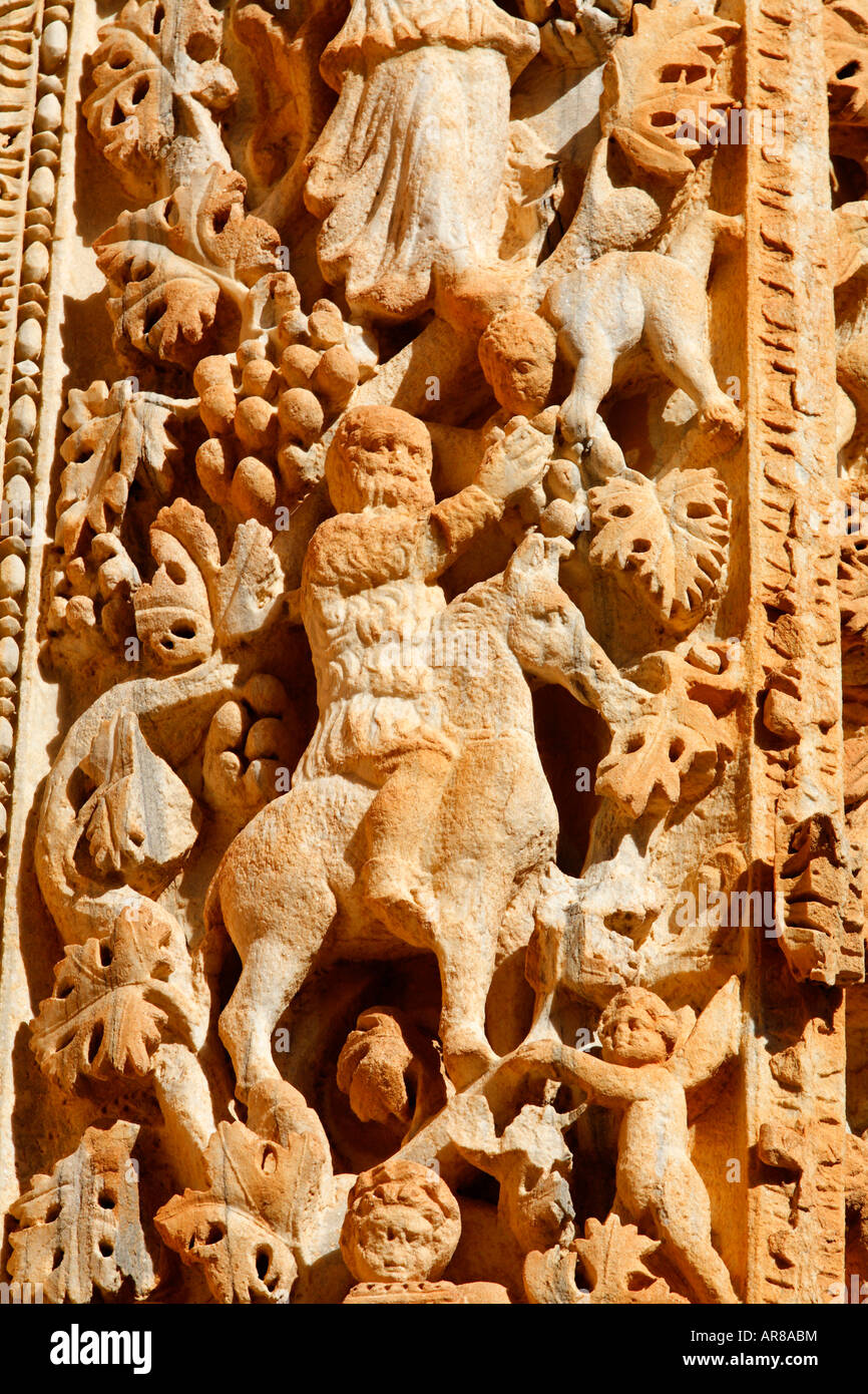 Ornately sculpted pillar with figures from the Dionysian procession at the Basilica of Severus Leptis Magna Libya Stock Photo