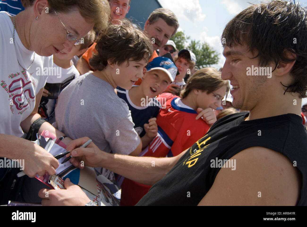 Alexander Ovechkin is signing a T-shirt for a fan on September 17th 2006 Alexander's birthday after the team practice game. Stock Photo