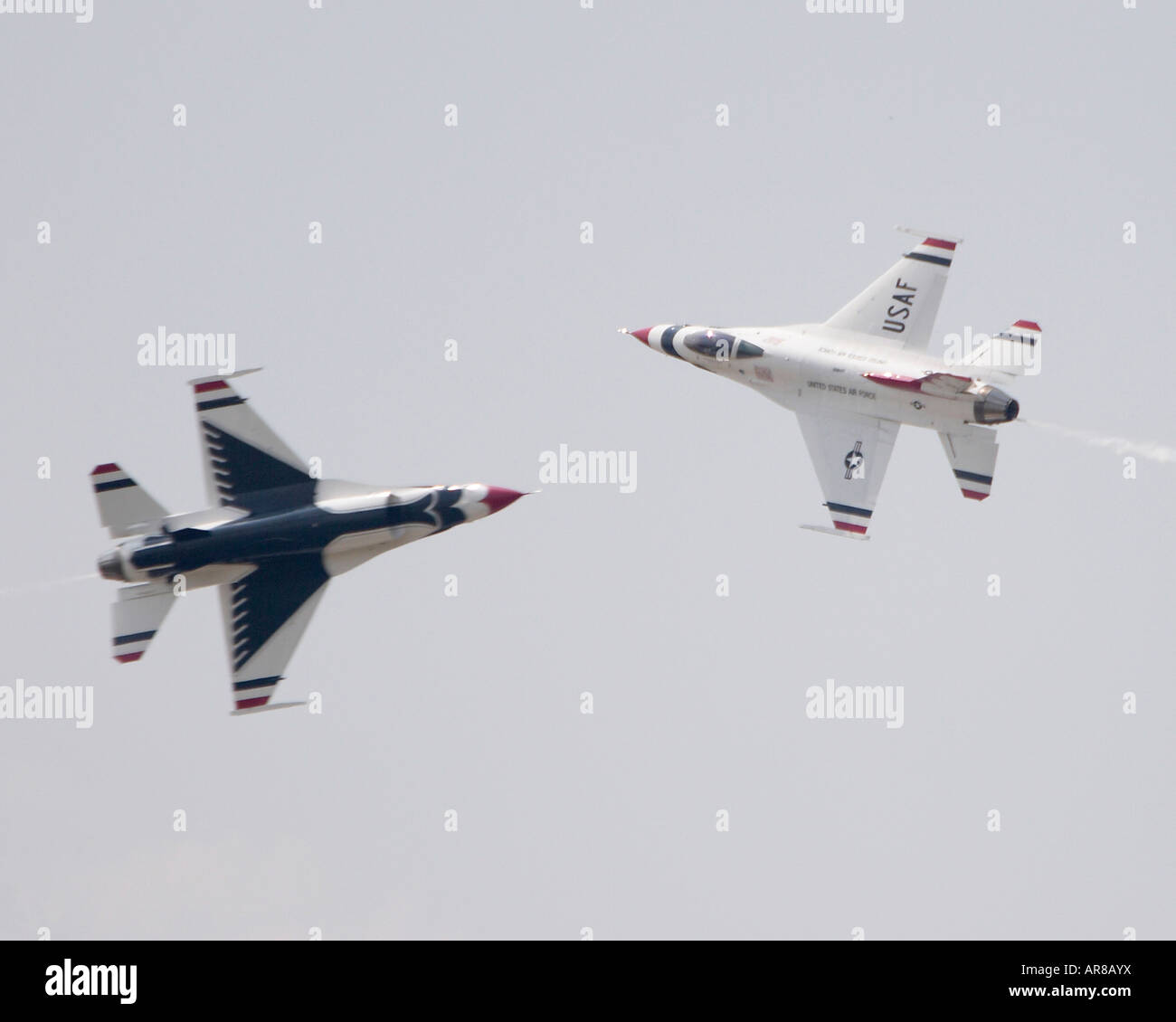 The USAF Thunderbirds F16 aircraft flying in a knife edge pass Stock