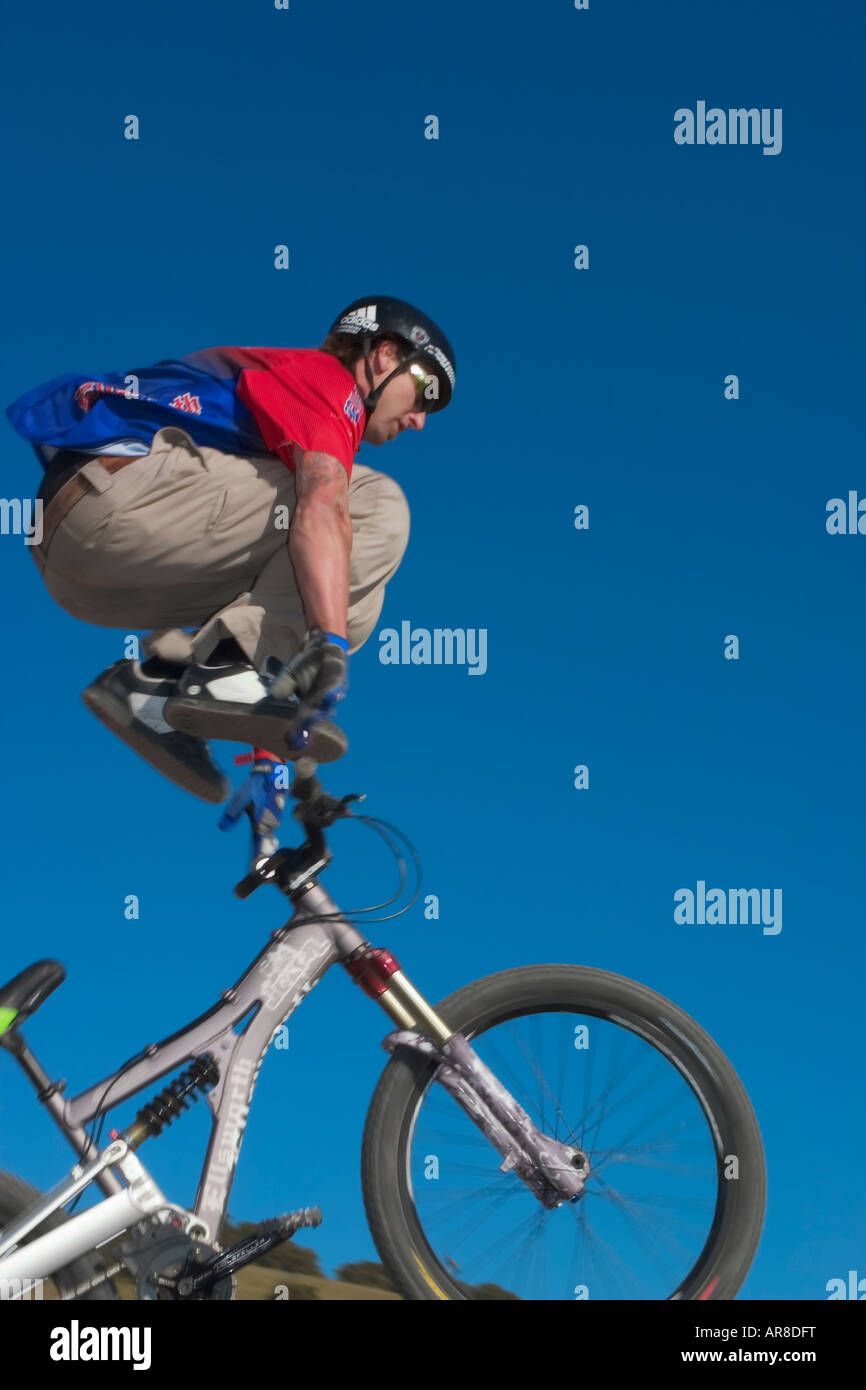 Bicycle acrobat jumping over handlebars in mid air Stock Photo Alamy