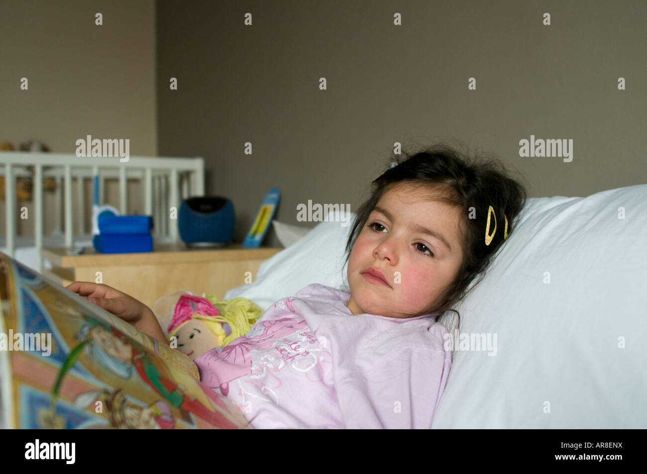 Sick child laying in bed Stock Photo Alamy