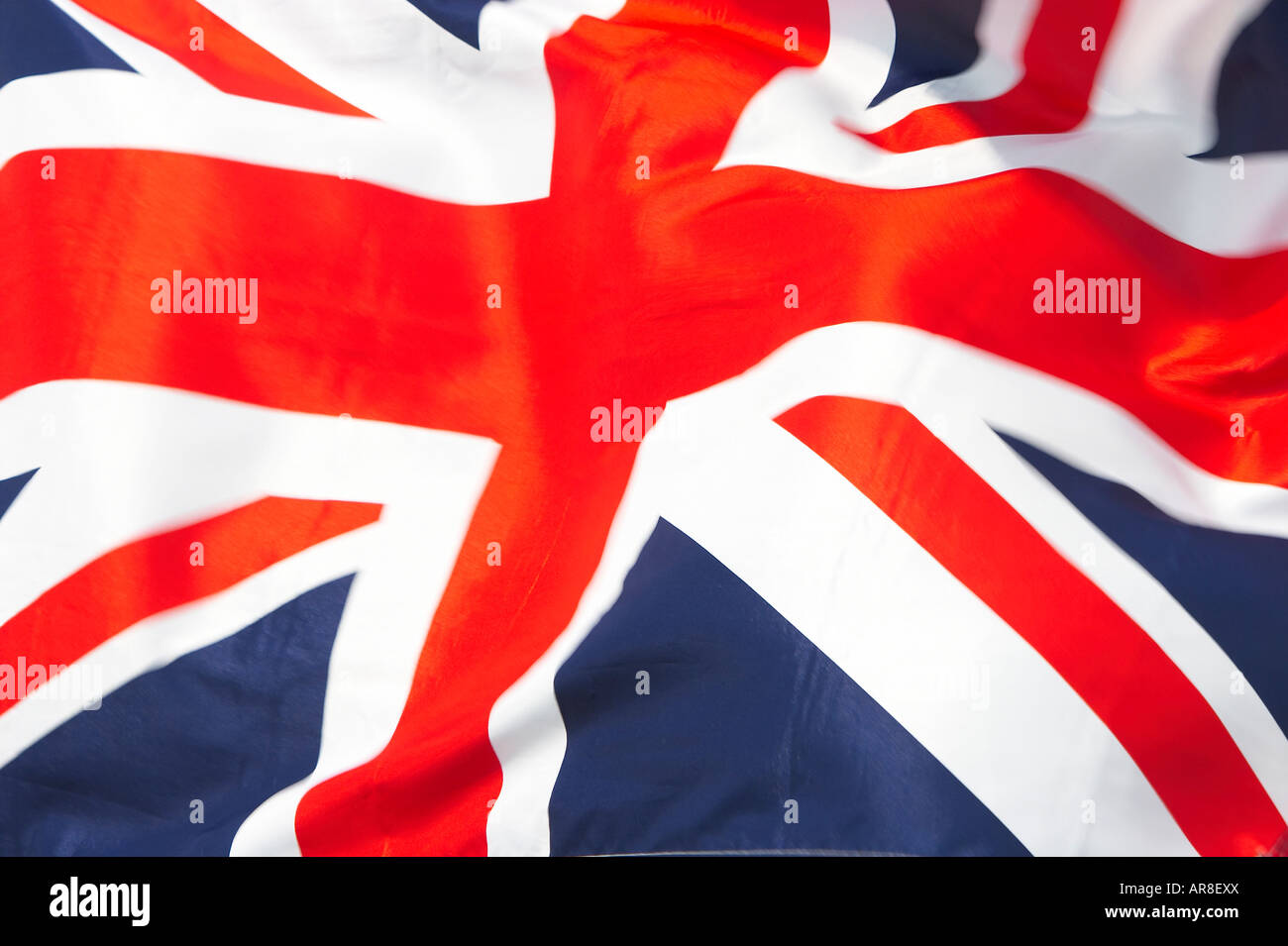 A Union Jack flag blowing in the wind close up Stock Photo - Alamy