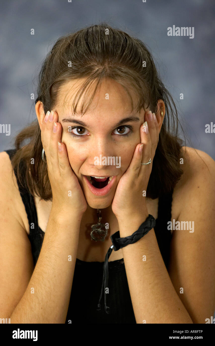 A cute young caucasian woman looking shocked surprised Stock Photo - Alamy