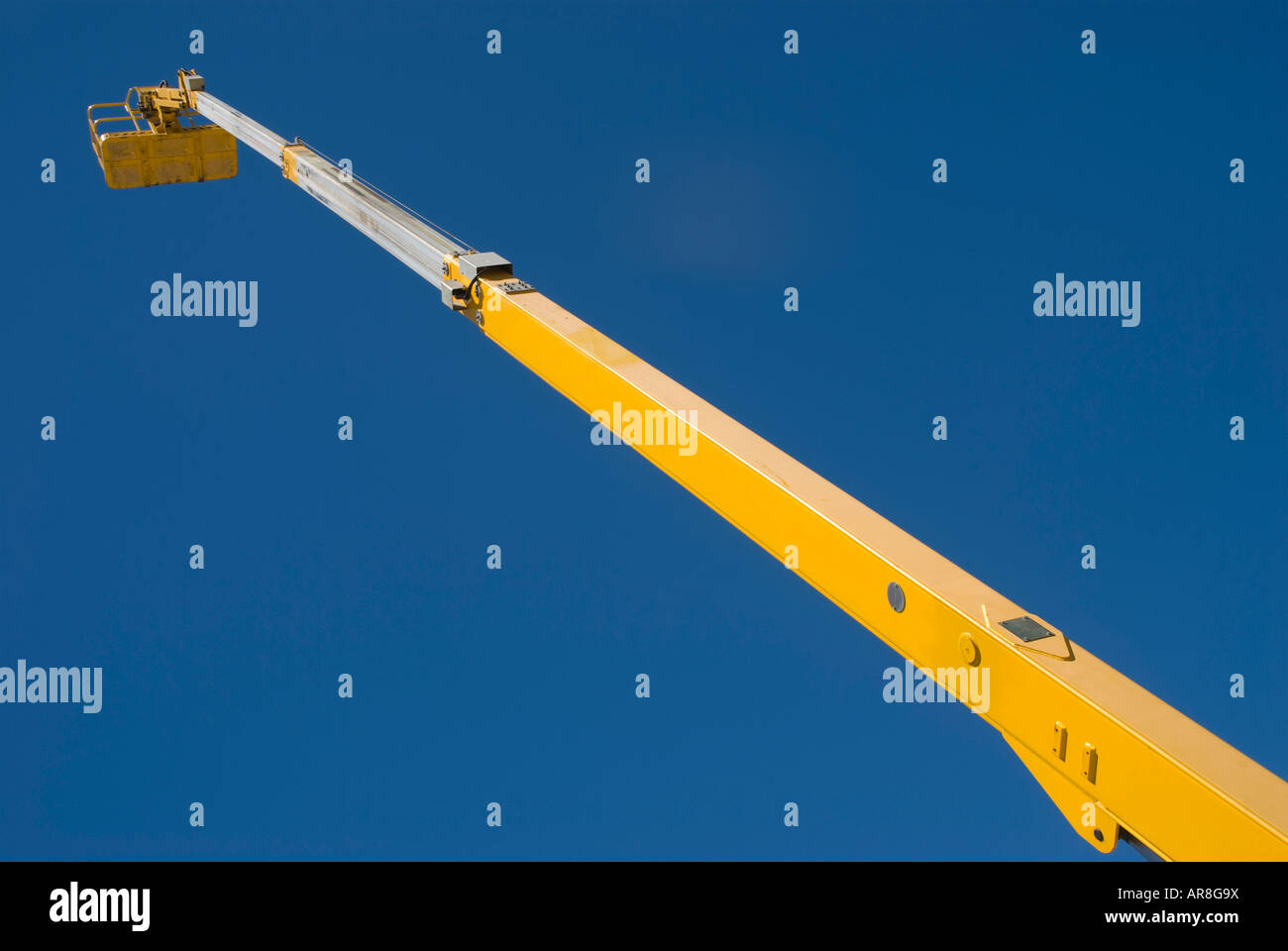 A very tall boom lift in use Stock Photo