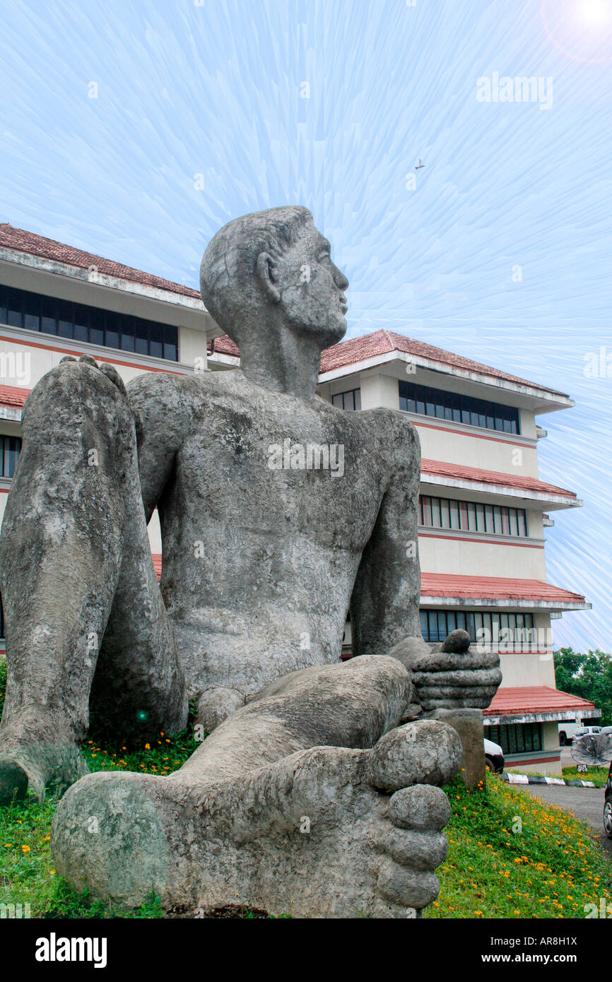 Sculpture of a man sitting up at Technopark. Concept is awakening - sleeping giant waking up to his immense potential Stock Photo