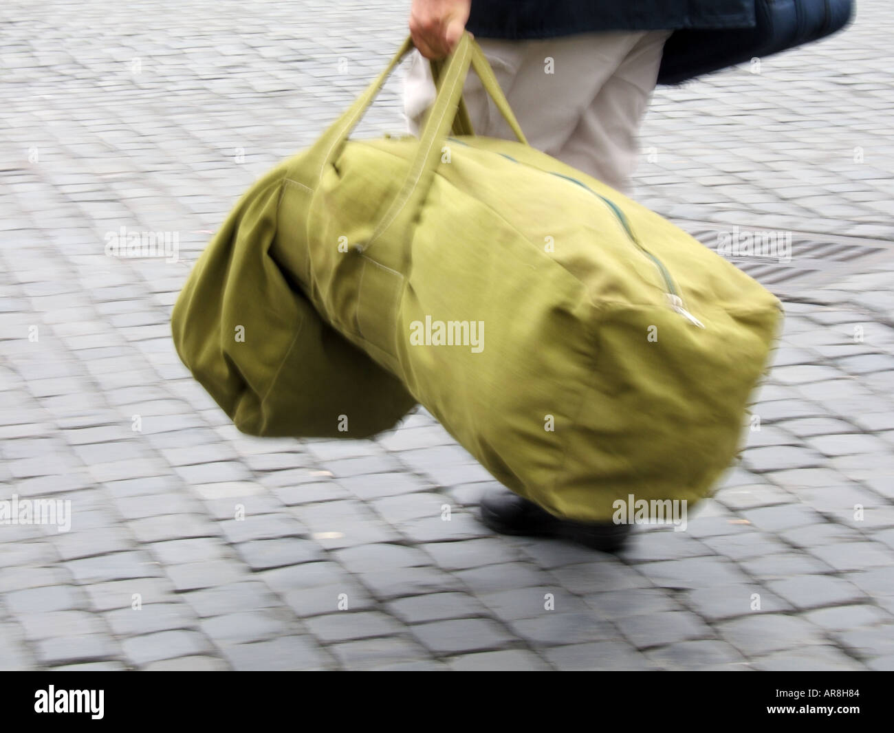 man carrying heavy holdall bag Stock Photo Alamy
