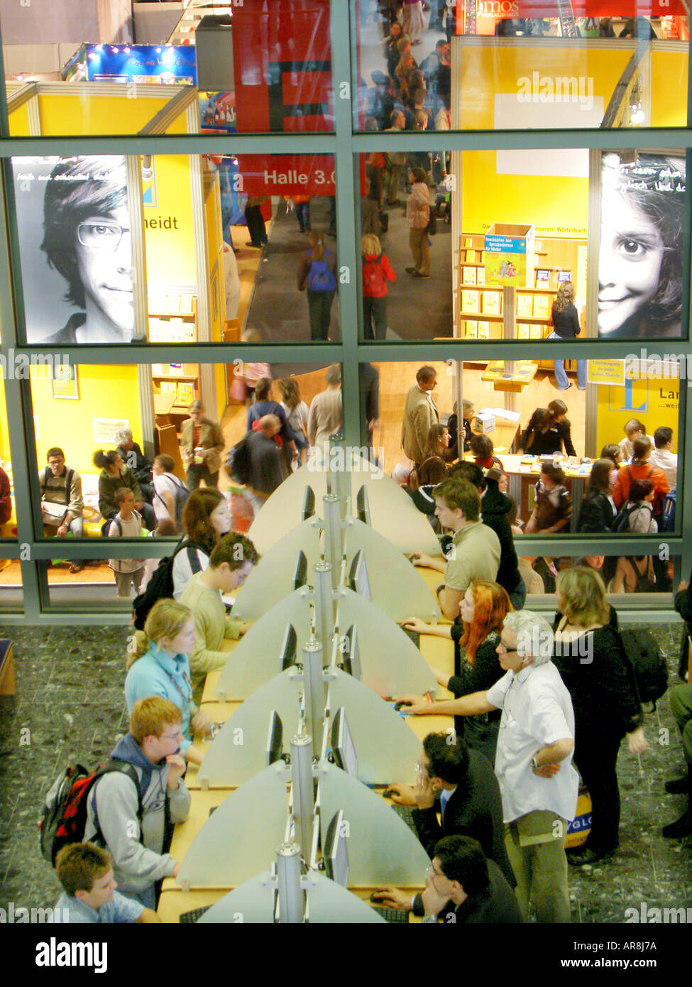 Frankfurt International Book Fair Buchmesse showing German publishers exhibition stands and visitors using computer terminals. Stock Photo