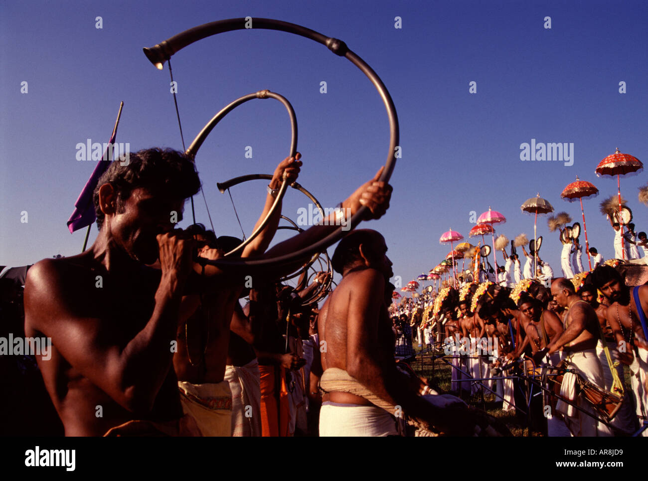 Men playing a type of horn wind instrument called sringa, also tutari