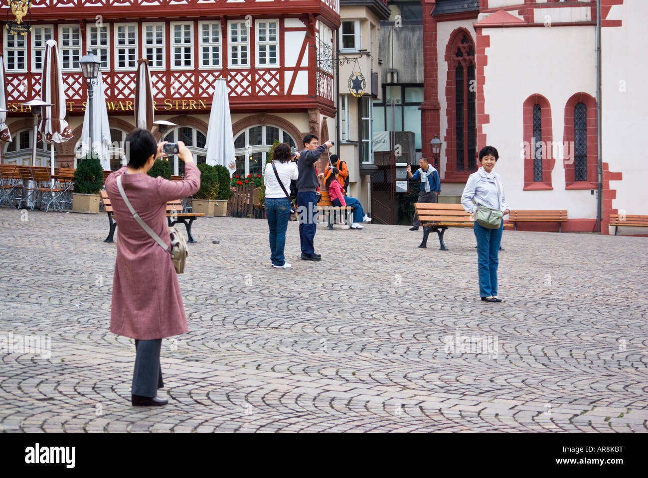 Chinese tourists photographing one another, Stock Photo