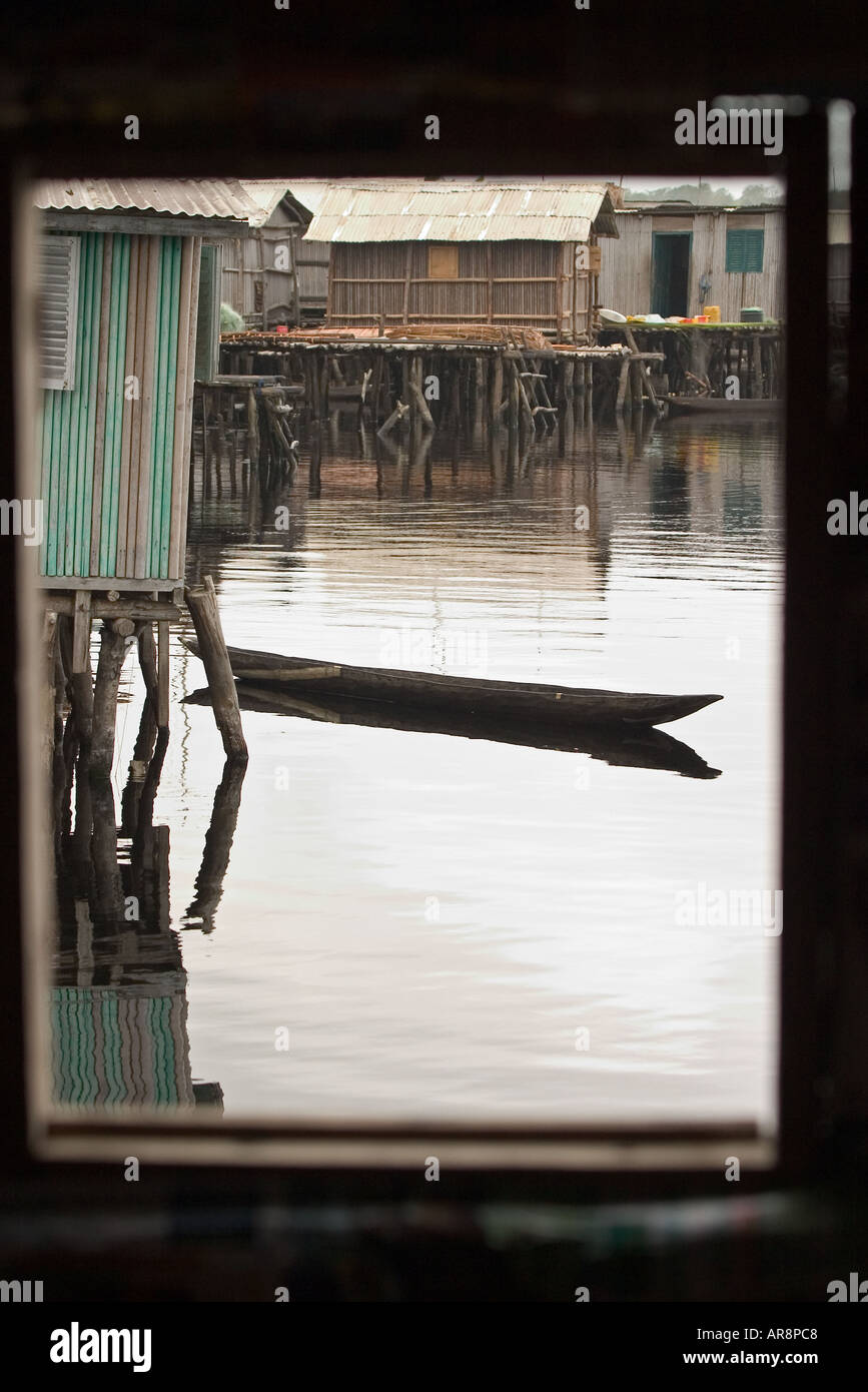 Dugout canoe seen through window of house at village on stilts of Nzuelzo, Western Ghana. Stock Photo
