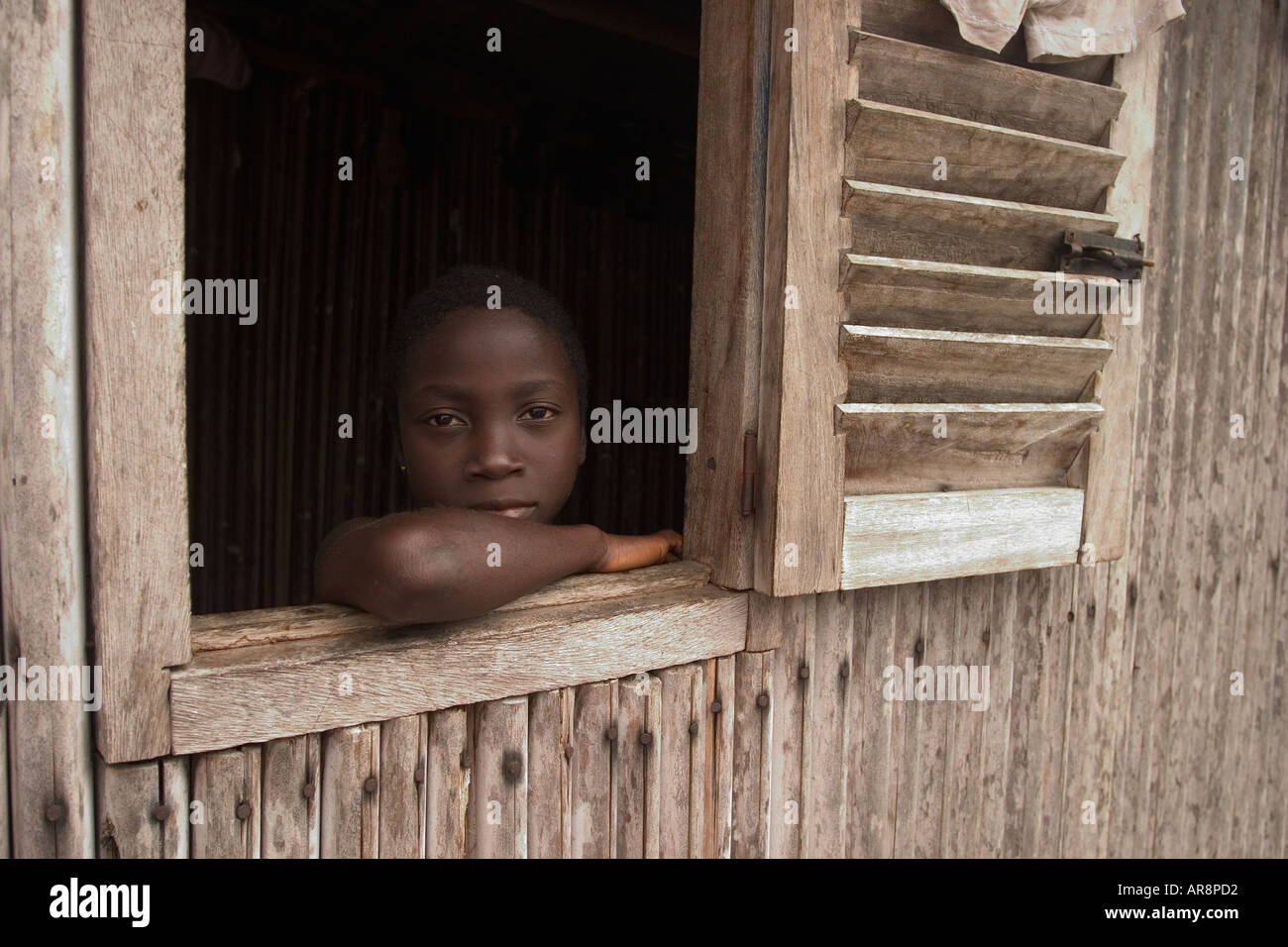 Ghanaian girl in a window at Nzuelzo, Western Ghana Stock Photo