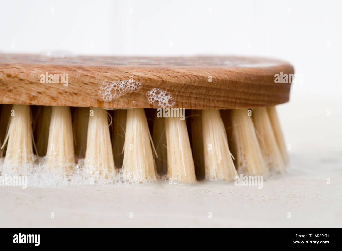 Scrubbing brush with natural soap flakes Stock Photo