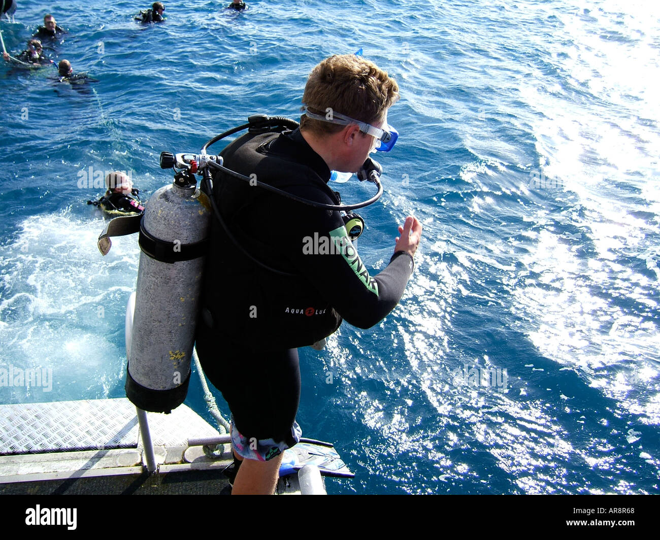 Scuba diver jumping into the water from a dive boat.Coastal waters