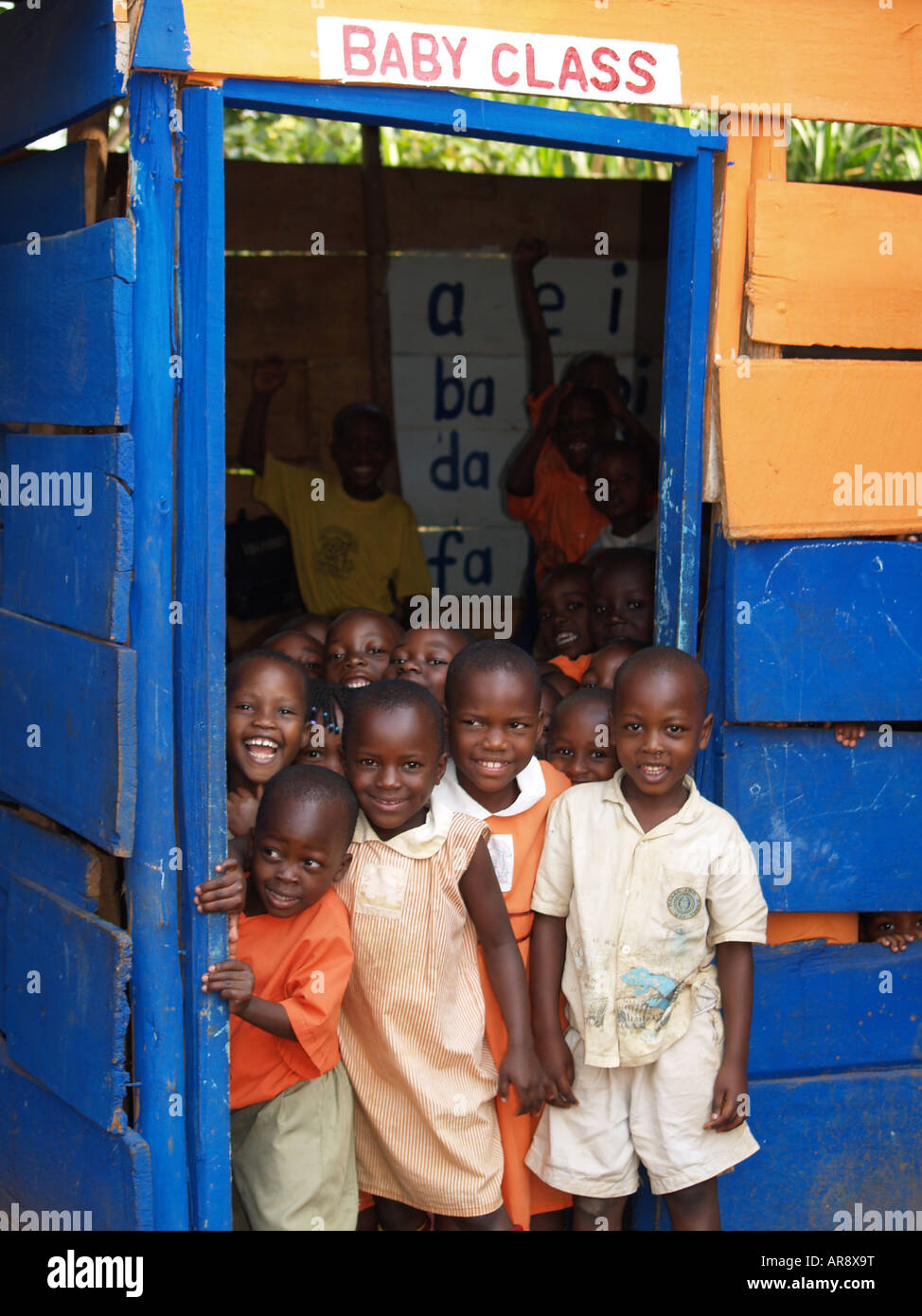 A group of school children standing by classroom door in Uganada East Africa Stock Photo