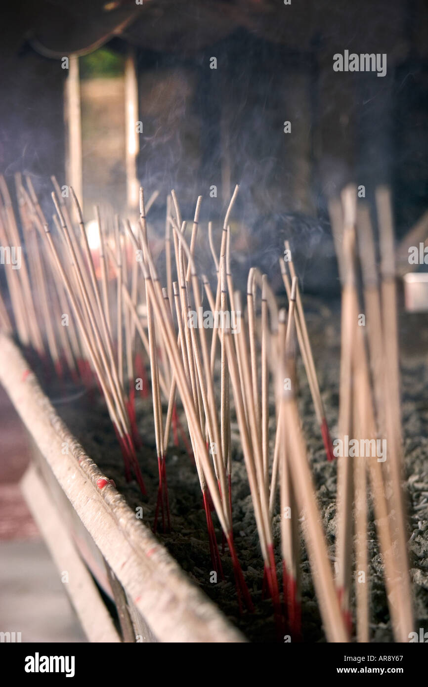 Burning incense sticks in a stand inside a Thai Temle called Wat Phra Thong on the island of